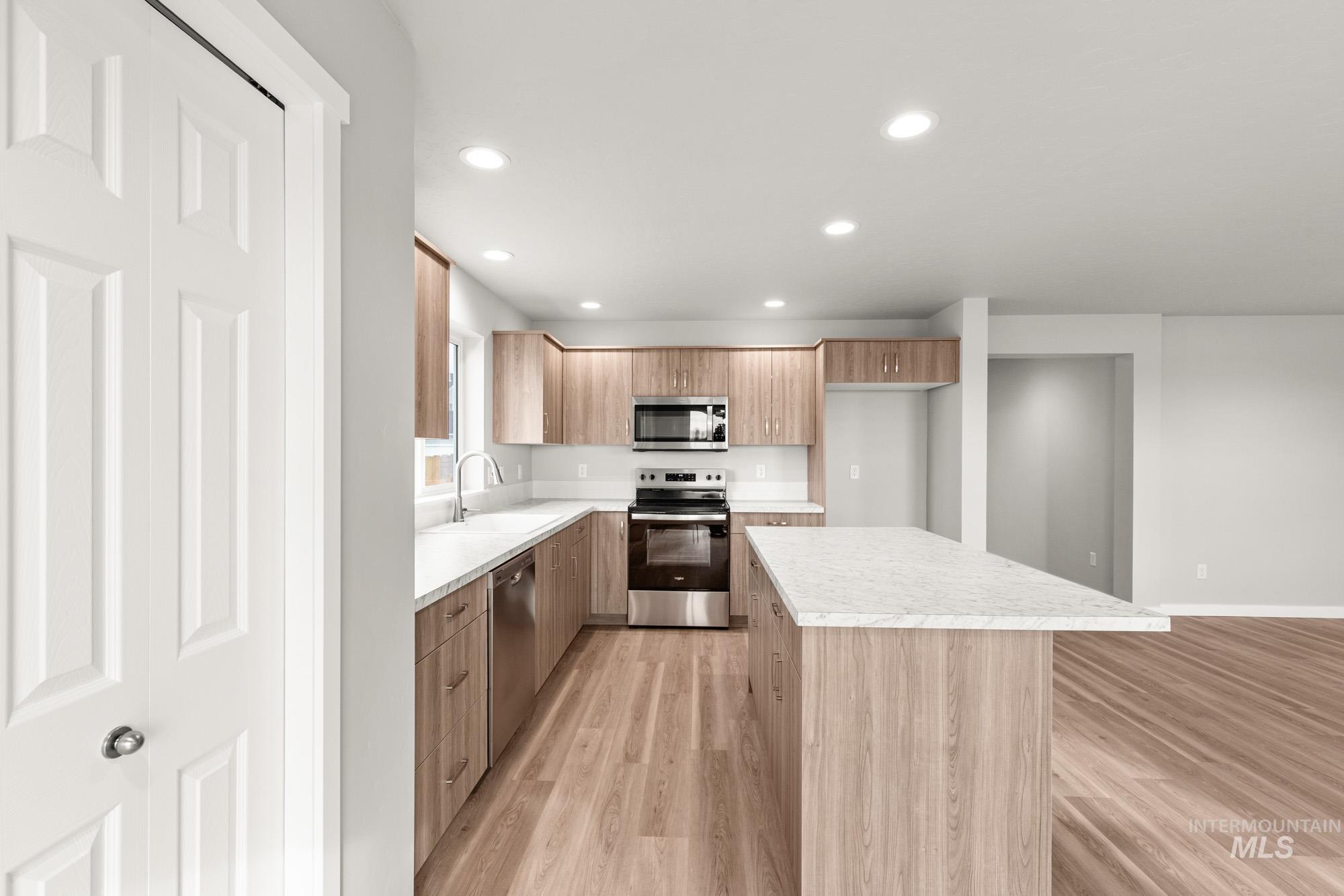 1515 Long Pond Street Middleton, ID 83644 - Photo 6 of 25 Kitchen with stainless steel appliances, light countertops, light wood-style flooring, and recessed lighting