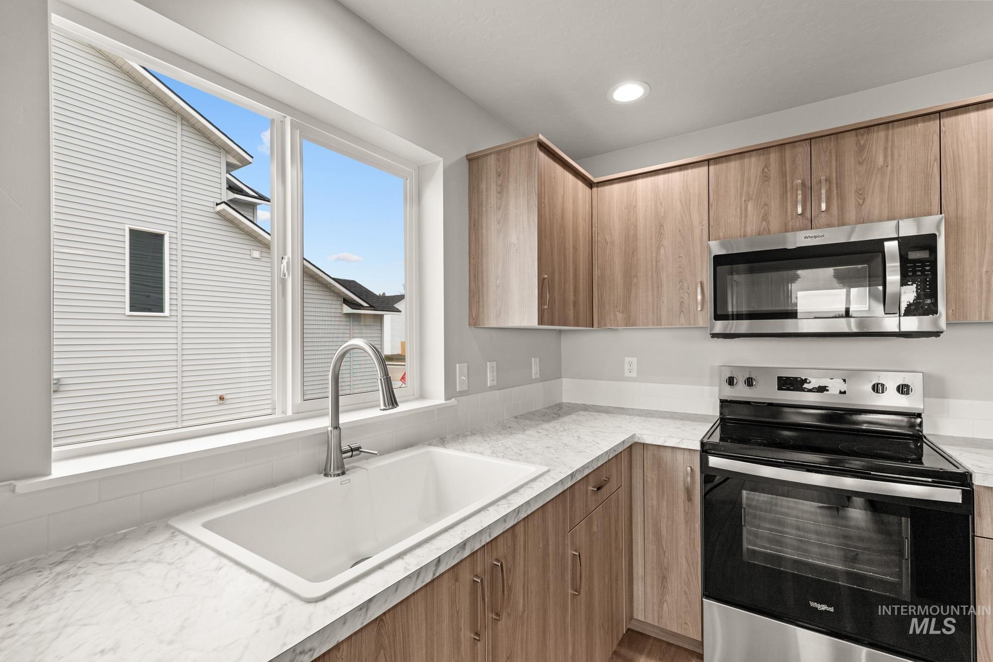1515 Long Pond Street Middleton, ID 83644 - Photo 7 of 25 Kitchen with stainless steel appliances, light countertops, recessed lighting, and modern cabinets