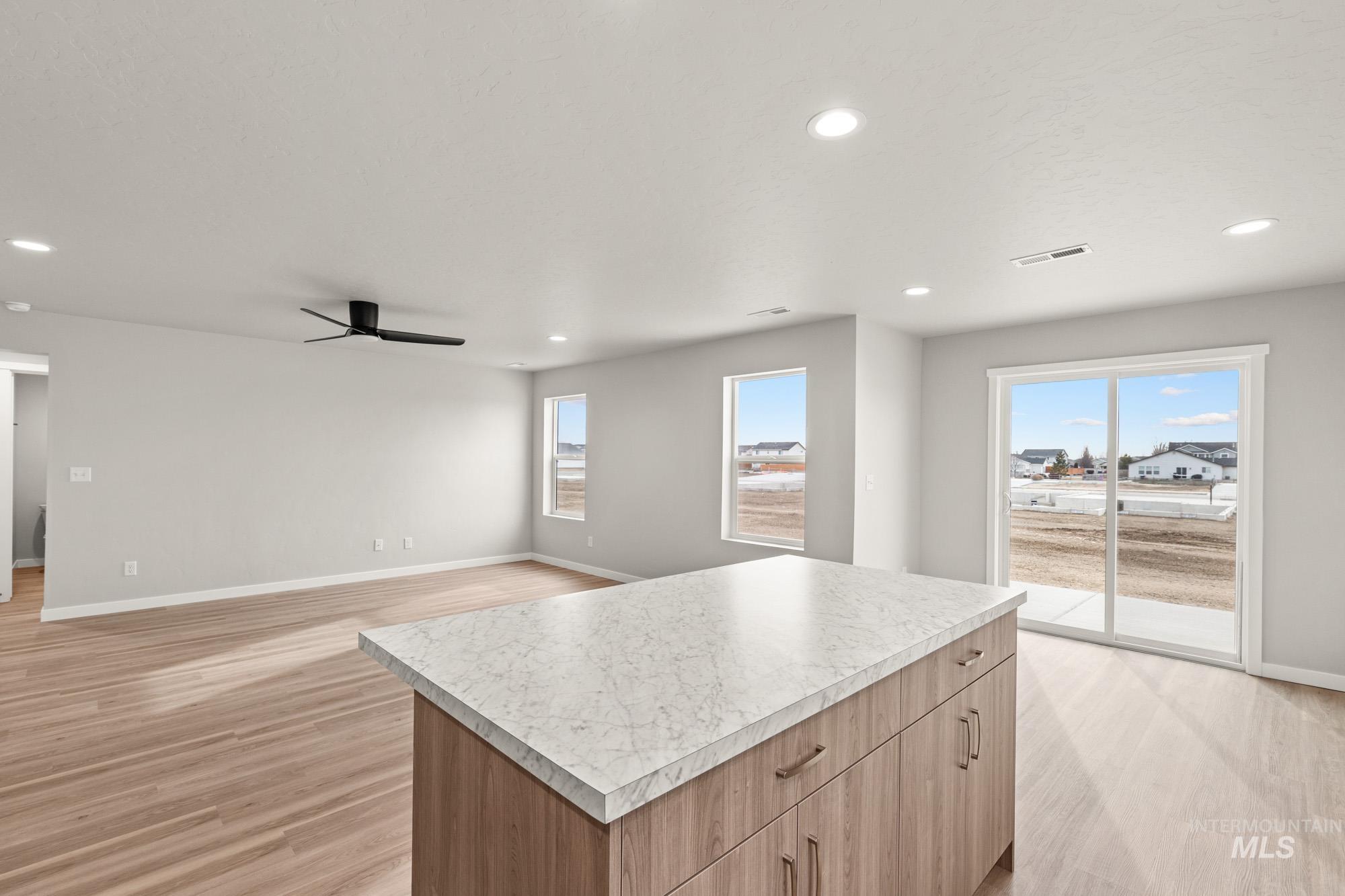 1515 Long Pond Street Middleton, ID 83644 - Photo 23 of 25 Kitchen with a kitchen island, light countertops, recessed lighting, light wood finished floors, and open floor plan