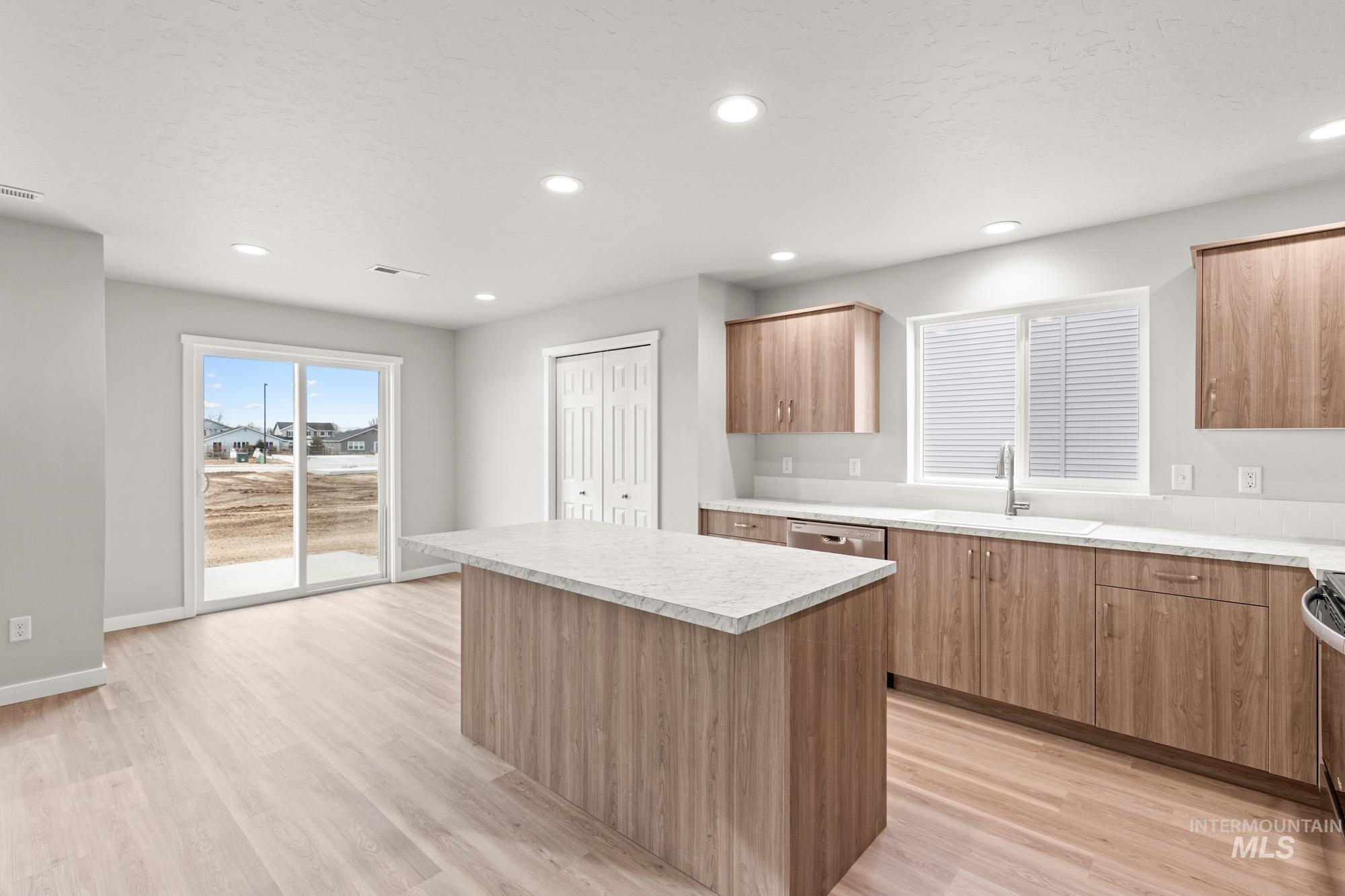 1515 Long Pond Street Middleton, ID 83644 - Photo 8 of 25 Kitchen with a kitchen island, light countertops, modern cabinets, light wood-style floors, and recessed lighting