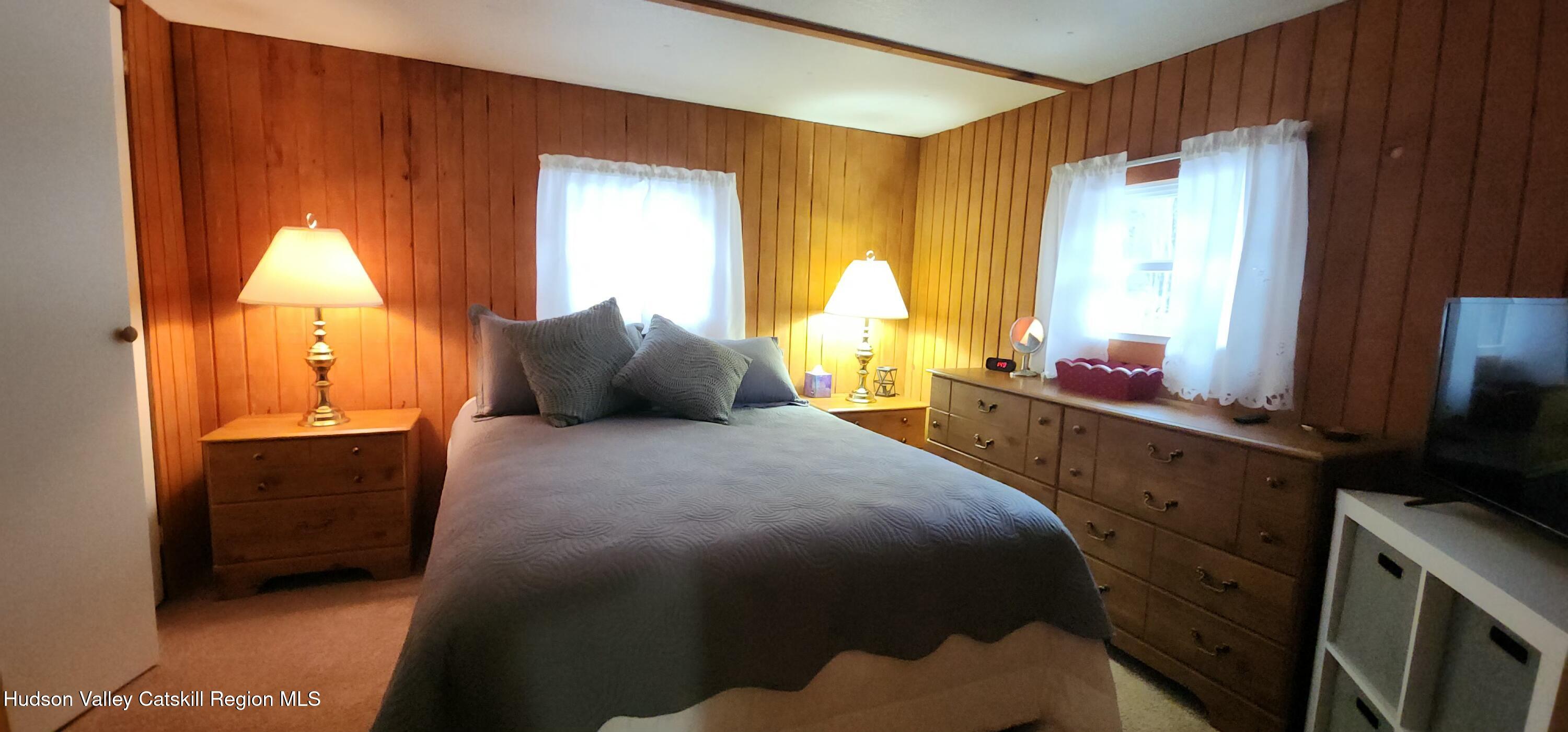 315 Begley Road Windham, NY 12496 - Photo 13 of 22 a bedroom with a bed and a window