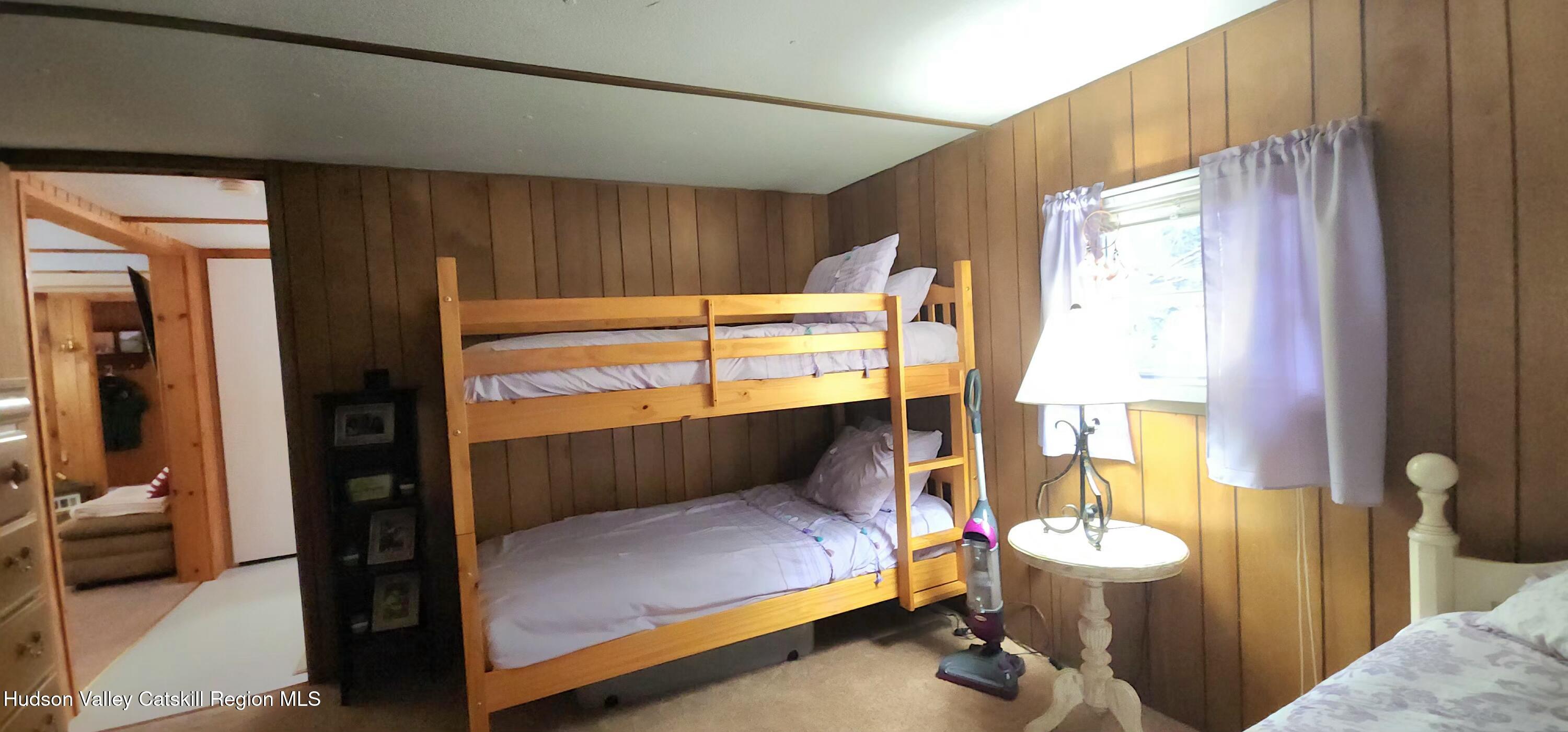 315 Begley Road Windham, NY 12496 - Photo 15 of 22 a bedroom with a bed and wooden floor