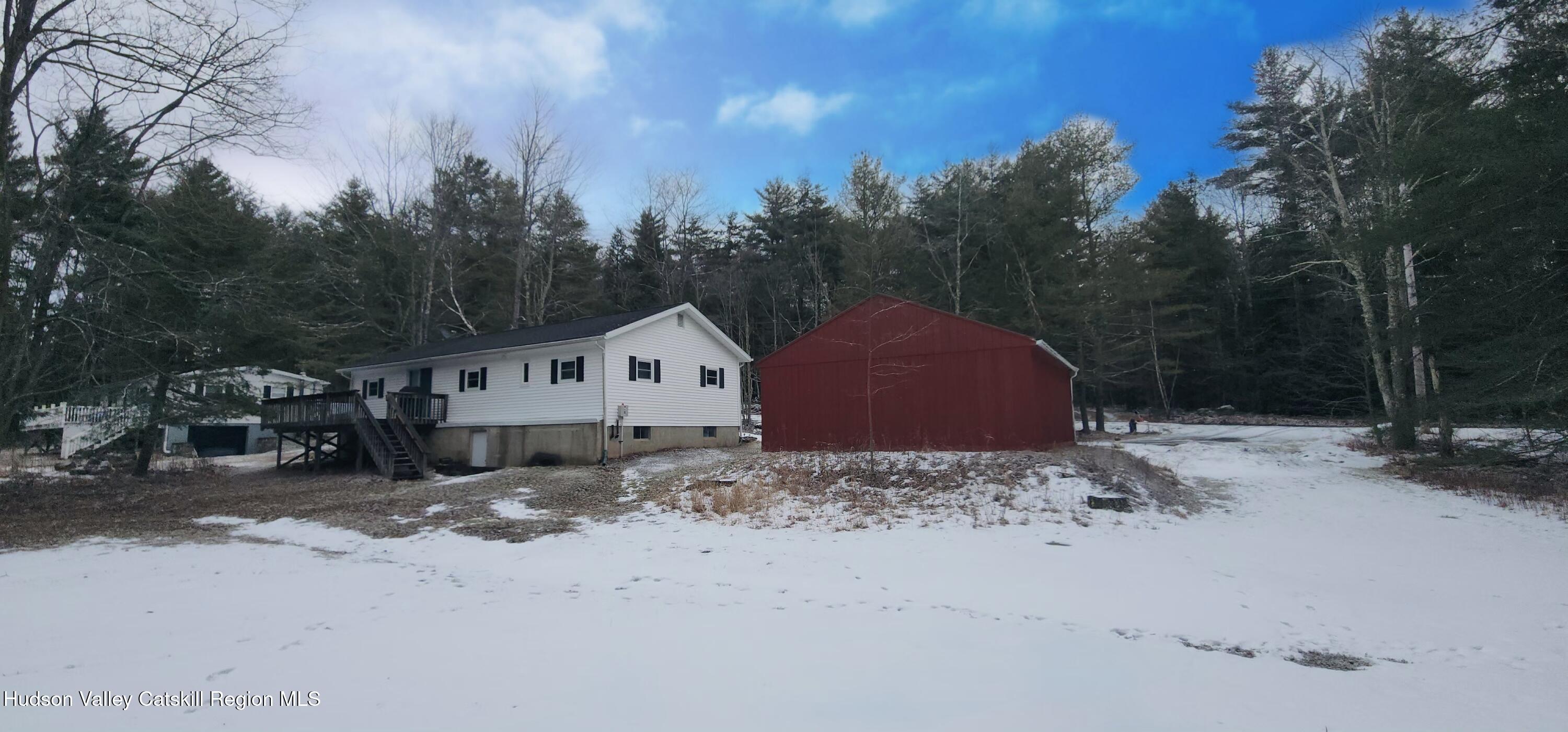 315 Begley Road Windham, NY 12496 - Photo 17 of 22 a view of a house with a yard covered with snow in the background