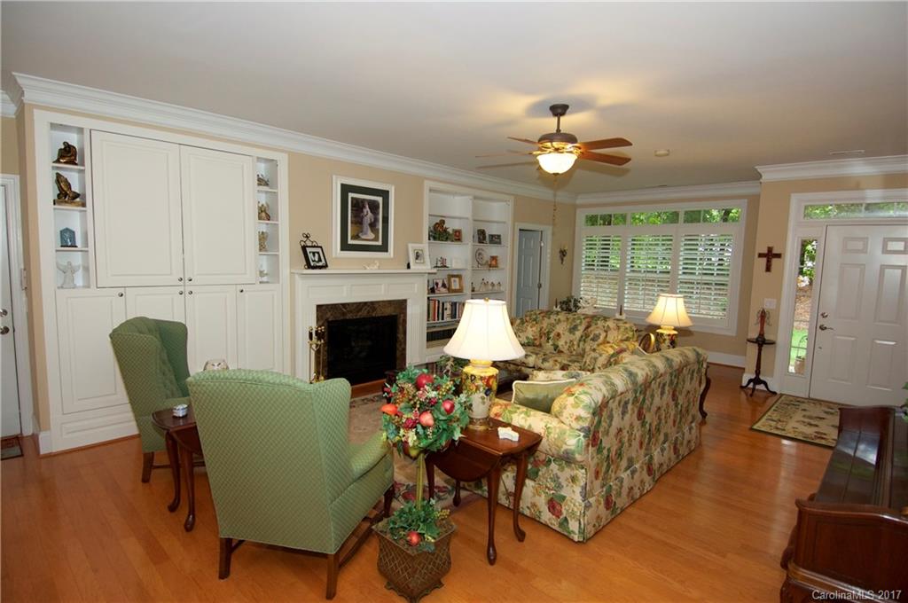 708 Congressional Lane, Unit D Fort Mill, SC 29708 - Photo 3 of 14 a living room with furniture a fireplace and a dining table with wooden floor