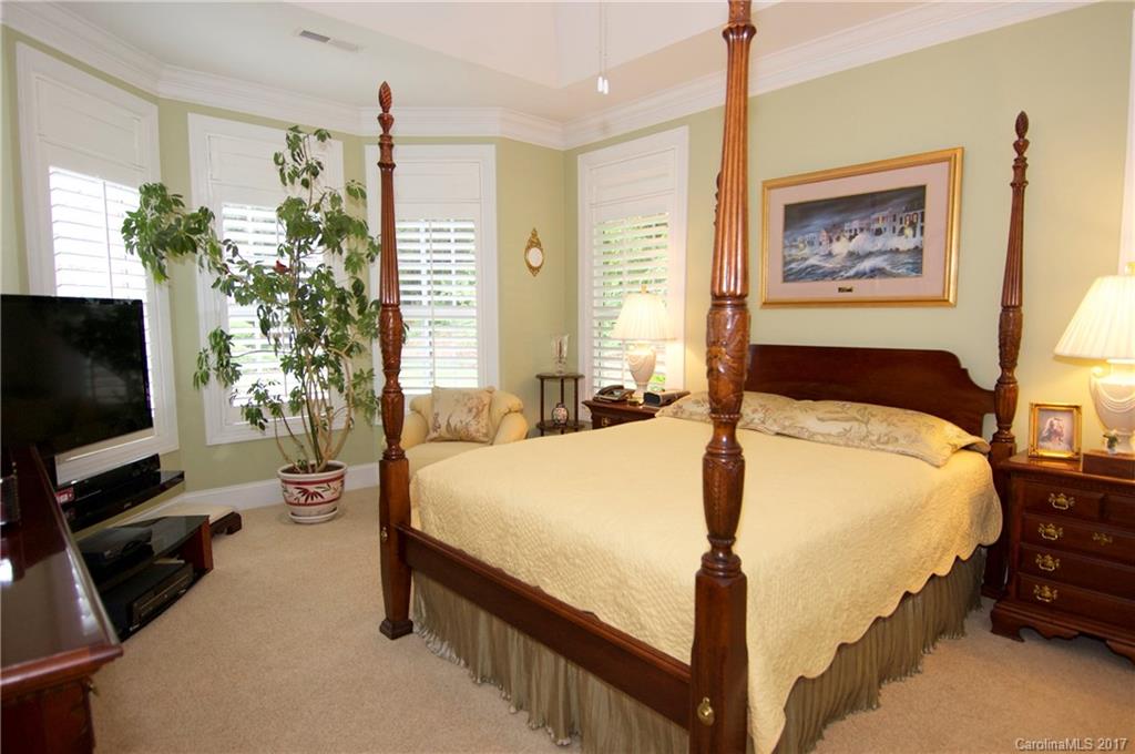 708 Congressional Lane, Unit D Fort Mill, SC 29708 - Photo 8 of 14 a bedroom with a bed and a flat screen tv