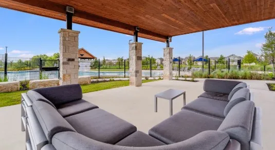 a patio with a patio table and chairs