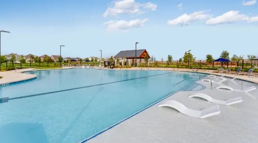 a view of a swimming pool and an outdoor seating