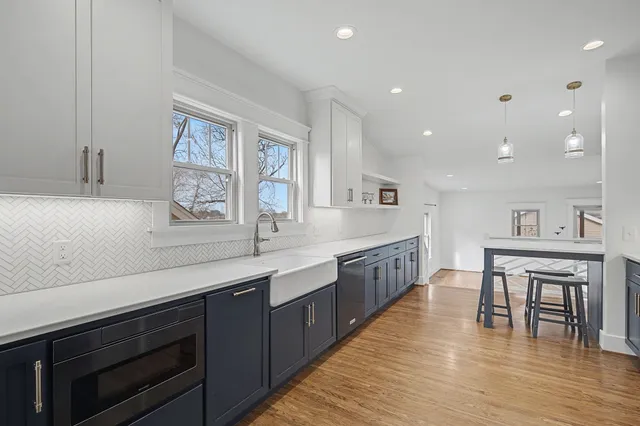 a stove top oven sitting inside of a kitchen