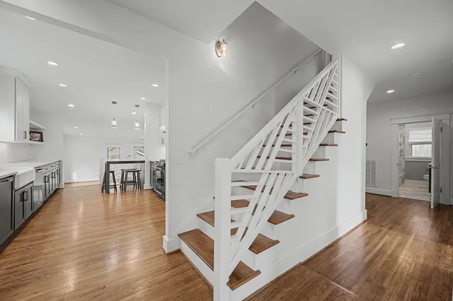 a large kitchen with stainless steel appliances granite countertop a sink counter space and wooden floor