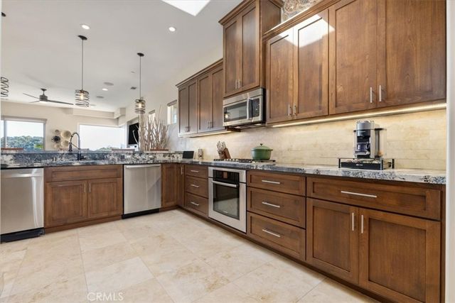 a bedroom with furniture and a large window