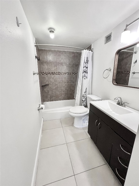 2016 Main Street, Unit 2405 Houston, TX 77002 - Photo 22 of 40 a bathroom with a sink a toilet a mirror and vanity