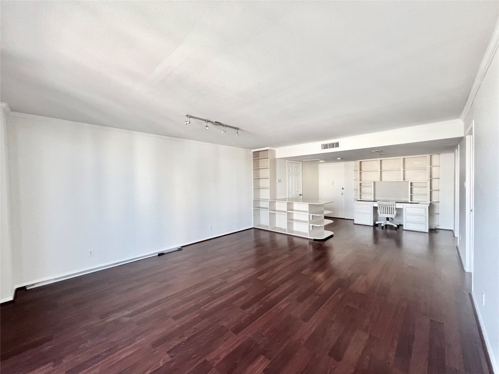2016 Main Street, Unit 2405 Houston, TX 77002 - Photo 5 of 40 a view of empty room with wooden floor and floor to ceiling window