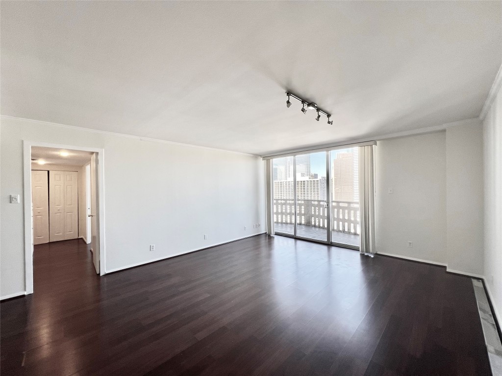 2016 Main Street, Unit 2405 Houston, TX 77002 - Photo 6 of 40 a view of an empty room with wooden floor and a window