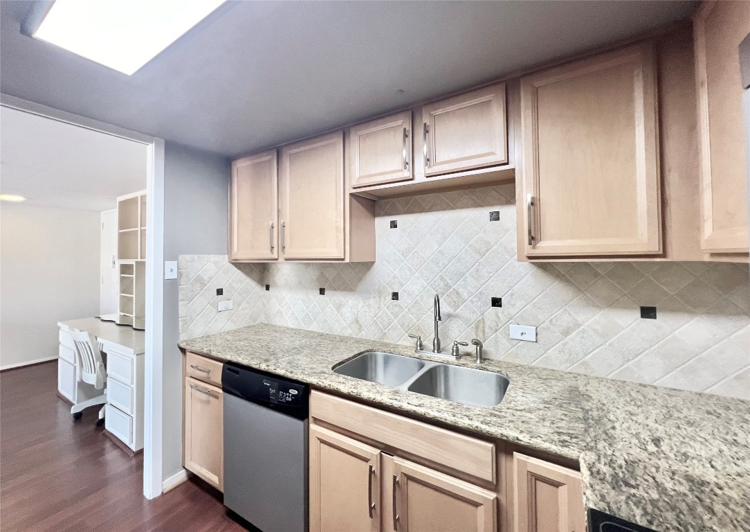 2016 Main Street, Unit 2405 Houston, TX 77002 - Photo 9 of 40 a kitchen with stainless steel appliances granite countertop a sink stove and cabinets