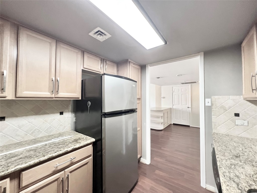 2016 Main Street, Unit 2405 Houston, TX 77002 - Photo 10 of 40 a kitchen with a refrigerator a sink and dishwasher with wooden floor