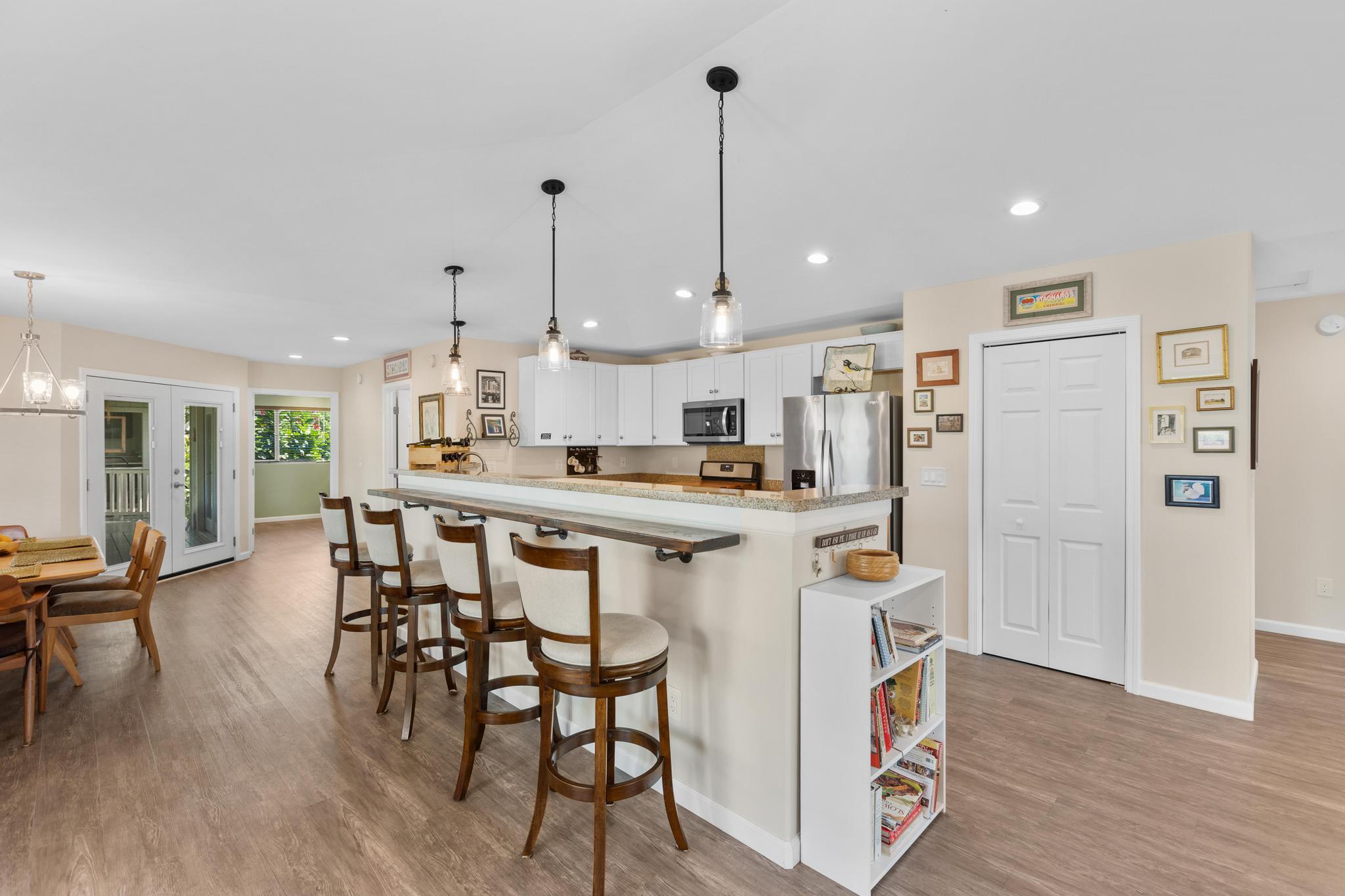 15-1635 Beach Road Keaau, HI 96749 - Photo 4 of 29 a kitchen with stainless steel appliances kitchen island wooden floors and white cabinets