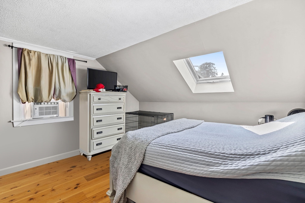 24 River Street, Unit B Danvers, MA 01923 - Photo 14 of 28 a bedroom with a bed and cabinet