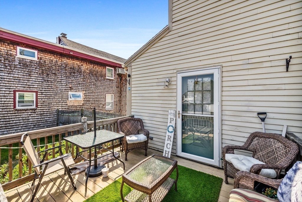 24 River Street, Unit B Danvers, MA 01923 - Photo 25 of 28 a backyard of a house with outdoor seating