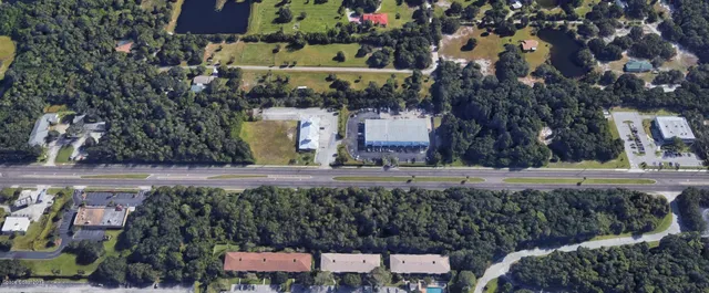 a sign board with buildings in the background