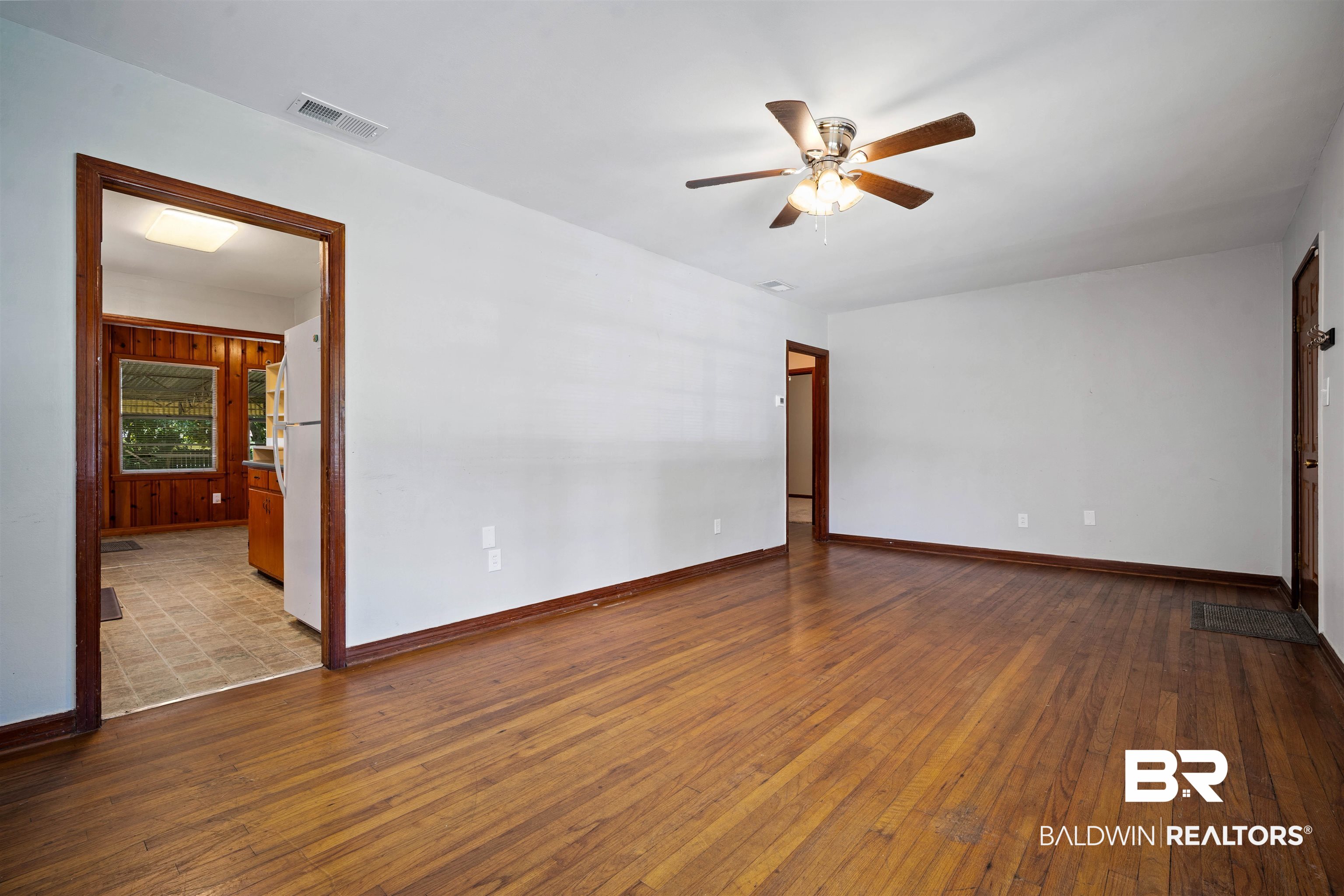 9 Elizabeth Avenue Mobile, AL 36611 - Photo 5 of 19 Empty room with a ceiling fan and wood-type flooring