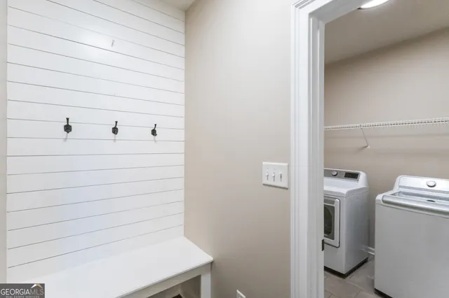 a bathroom with a tub a sink a window and a shower