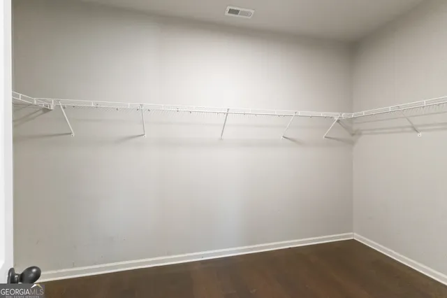 a large kitchen with stainless steel appliances kitchen island granite countertop a stove refrigerator and cabinets