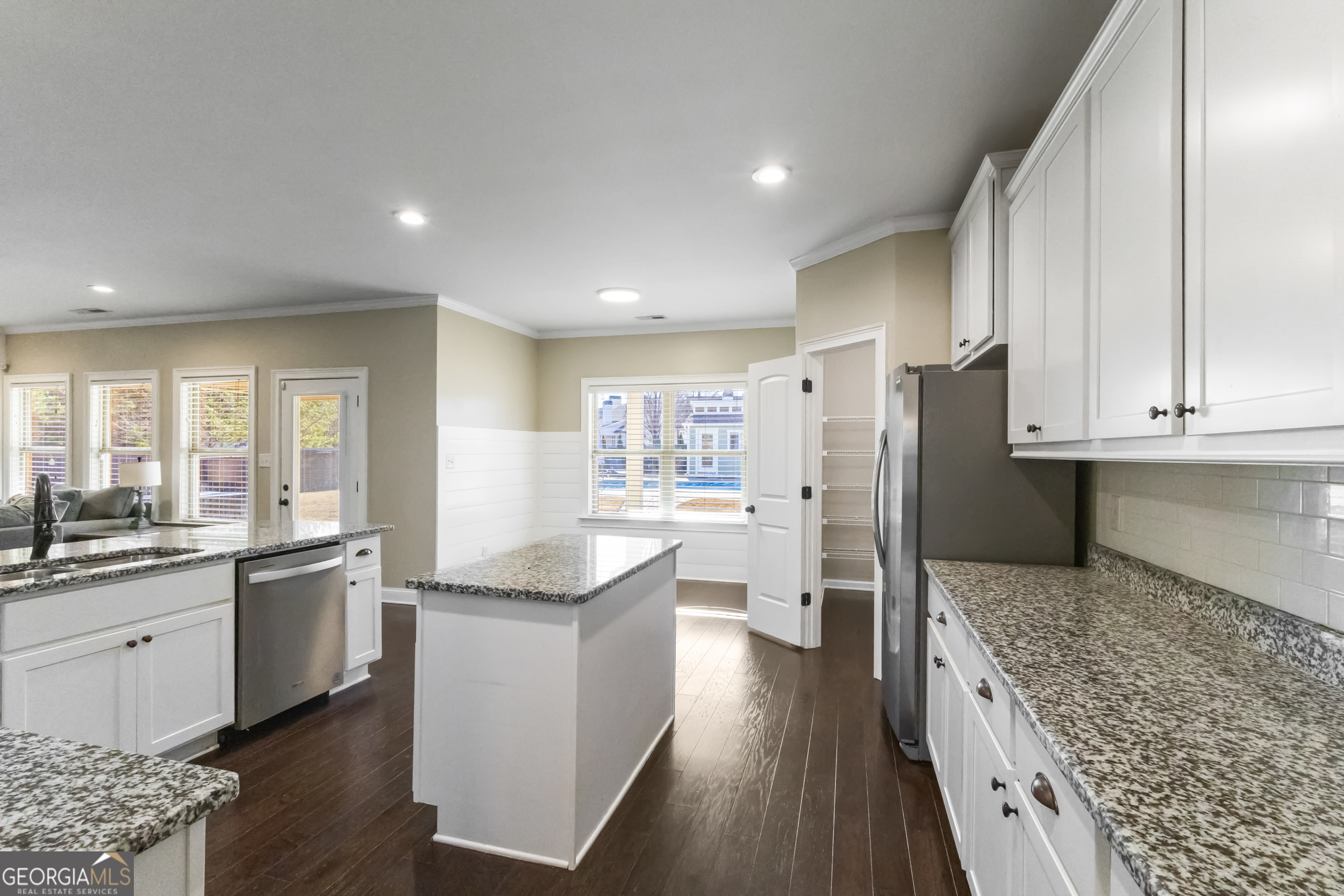 100 Wet Stone Road Senoia, GA 30276 - Photo 24 of 54 a large kitchen with stainless steel appliances kitchen island granite countertop a stove refrigerator and cabinets
