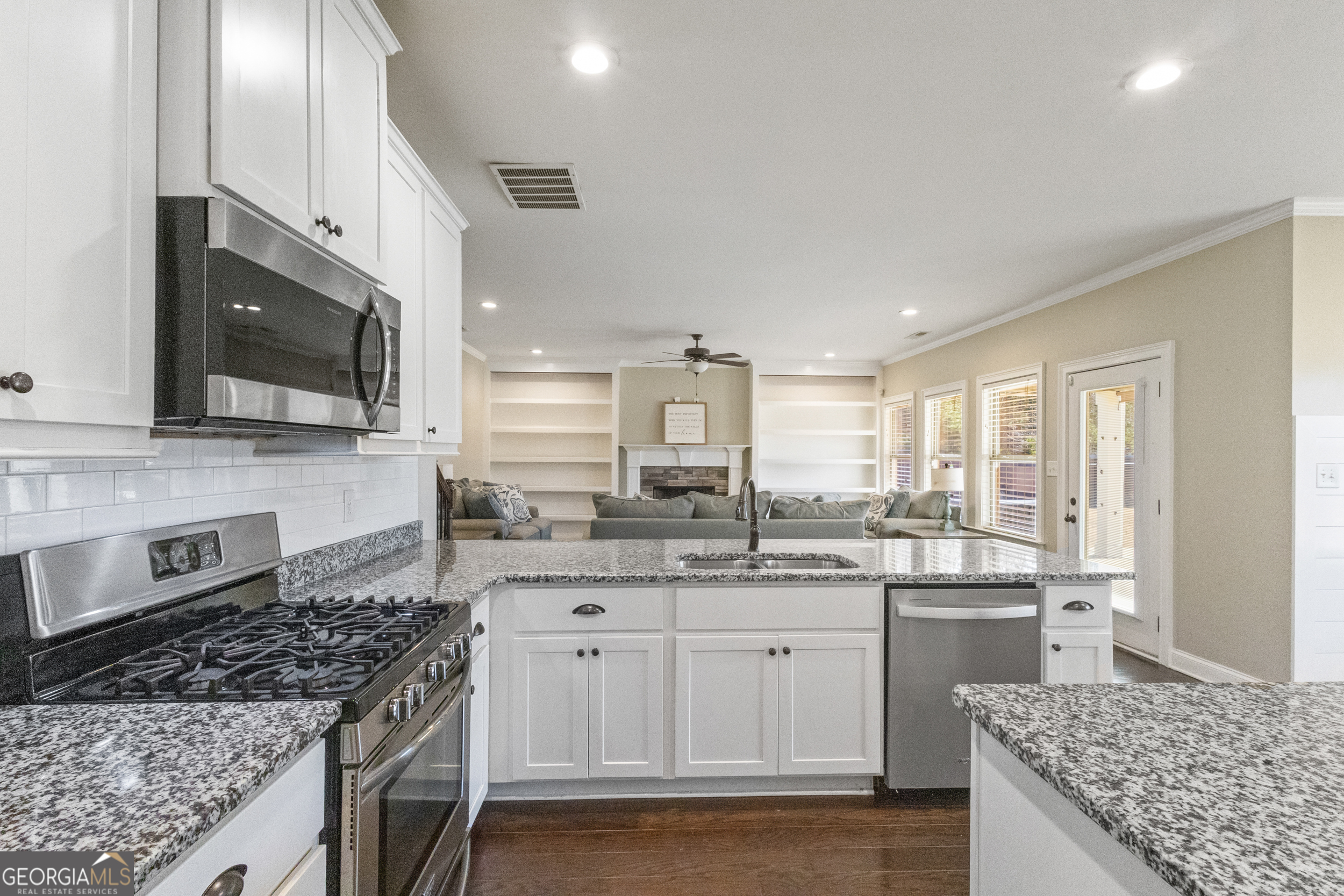 100 Wet Stone Road Senoia, GA 30276 - Photo 25 of 54 a kitchen with stainless steel appliances granite countertop a sink stove and refrigerator