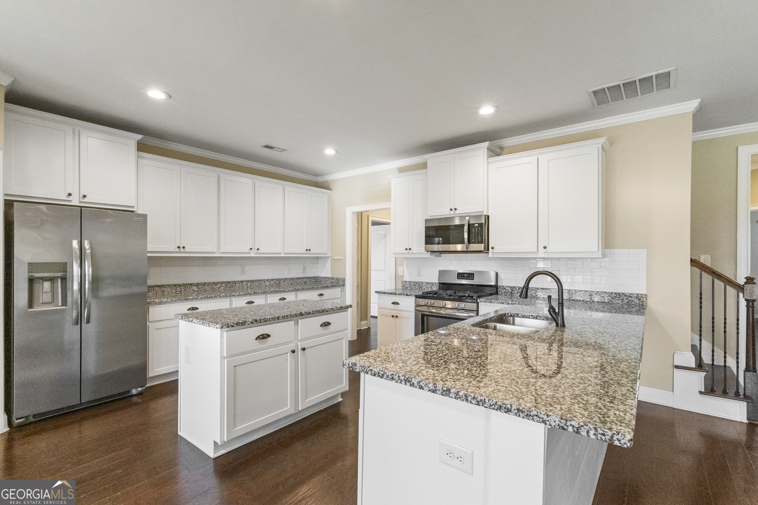 100 Wet Stone Road Senoia, GA 30276 - Photo 28 of 54 a kitchen with stainless steel appliances granite countertop a sink stove refrigerator and cabinets