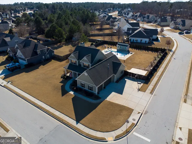 an aerial view of a house with swimming pool