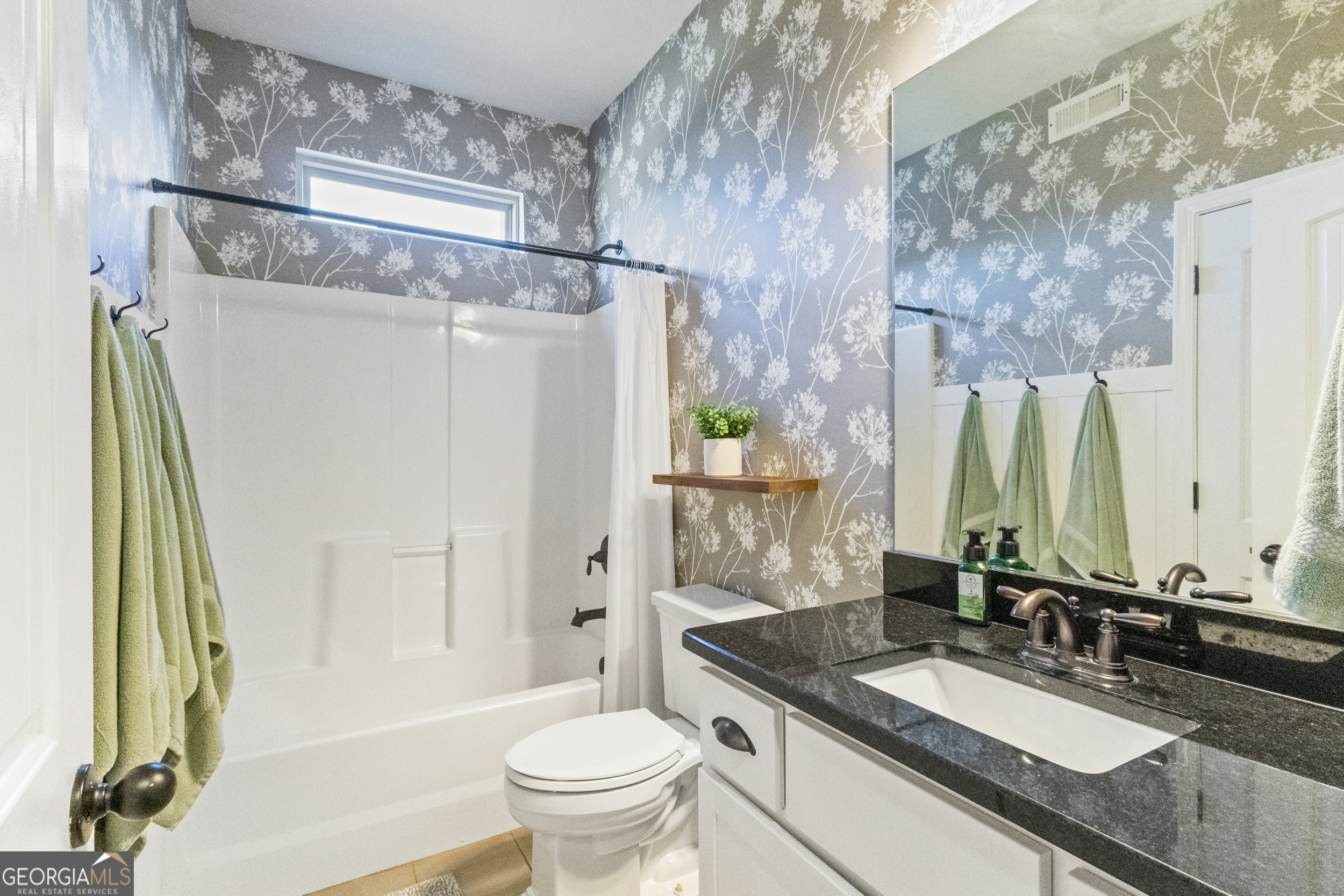 100 Wet Stone Road Senoia, GA 30276 - Photo 36 of 54 a bathroom with a granite countertop shower sink vanity mirror and toilet