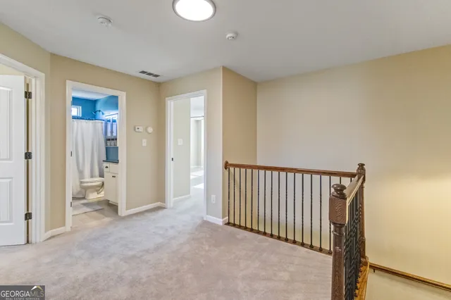 an empty room with a ceiling fan and window