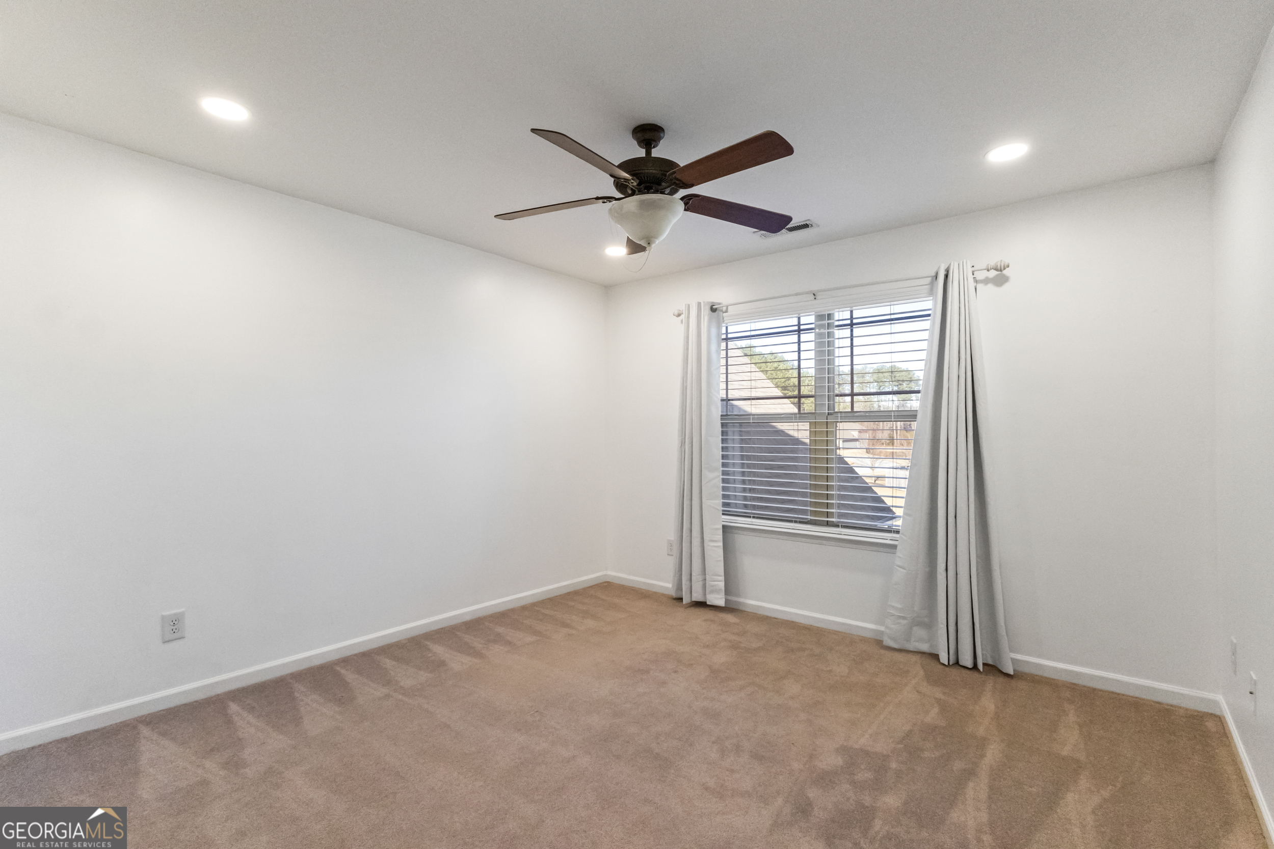 100 Wet Stone Road Senoia, GA 30276 - Photo 40 of 54 an empty room with windows and fan