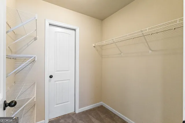 a view of a room with a ceiling fan
