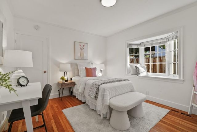 a spacious bedroom with a bed and window