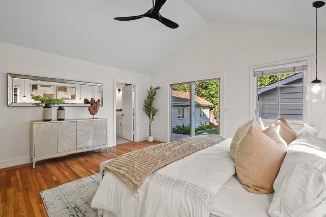 a bedroom with a bed and a large window