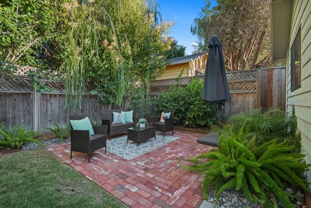 a view of a backyard with plants and a patio