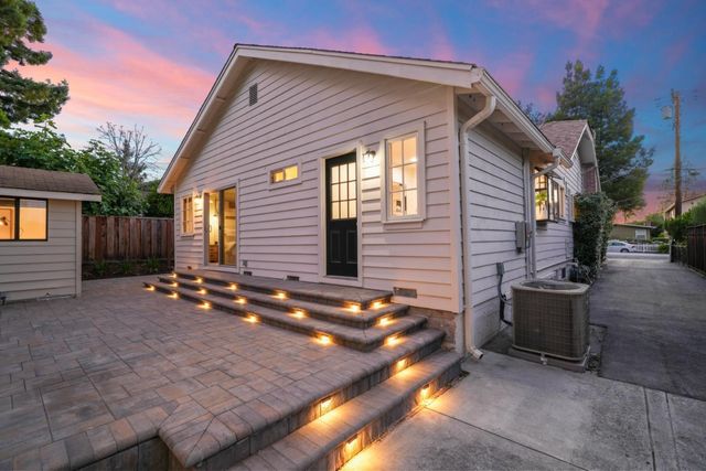 a backyard of a house with outdoor seating
