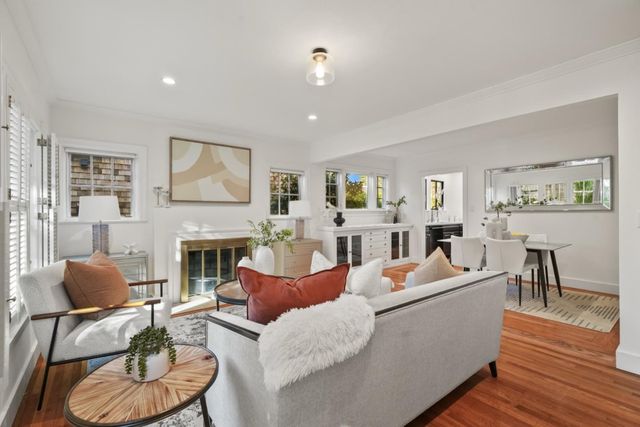 a living room with fireplace furniture and a wooden floor