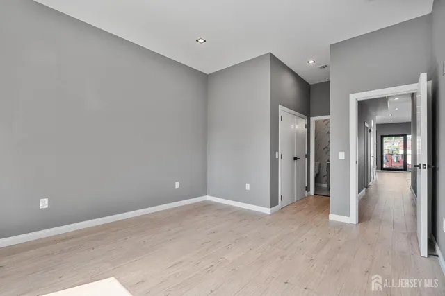 a view of a hallway with wooden shelves