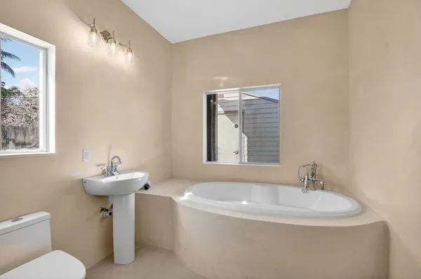 a bathroom with a sink a mirror and a toilet