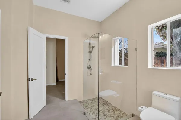 a bathroom with a shower and a toilet