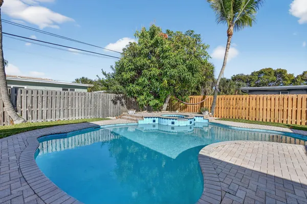 a view of a swimming pool with a patio and a garden