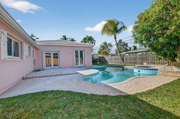 a view of a house with a backyard and a patio