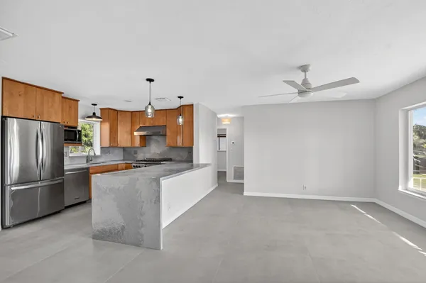 a large kitchen with cabinets and stainless steel appliances