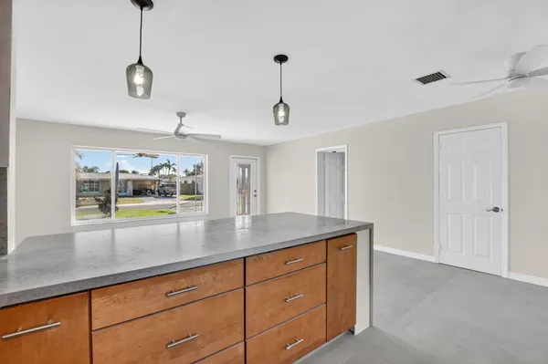 a view with a sink a counter space and a window