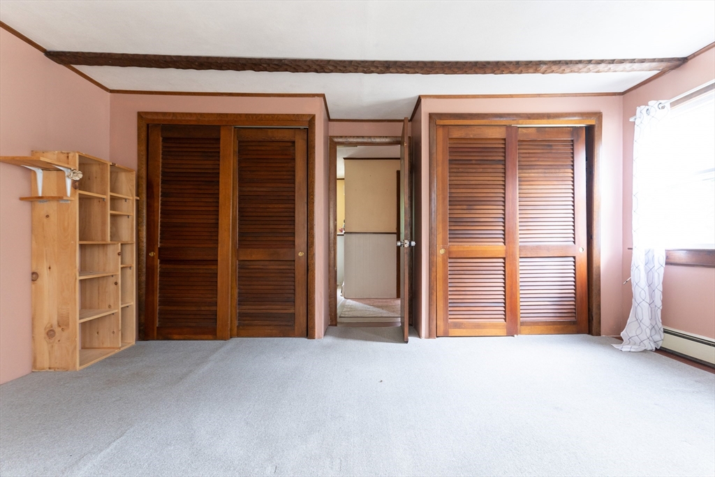 150 Framingham Road, Unit 2 Southborough, MA 01772 - Photo 11 of 20 a view of an empty room with closet and a window