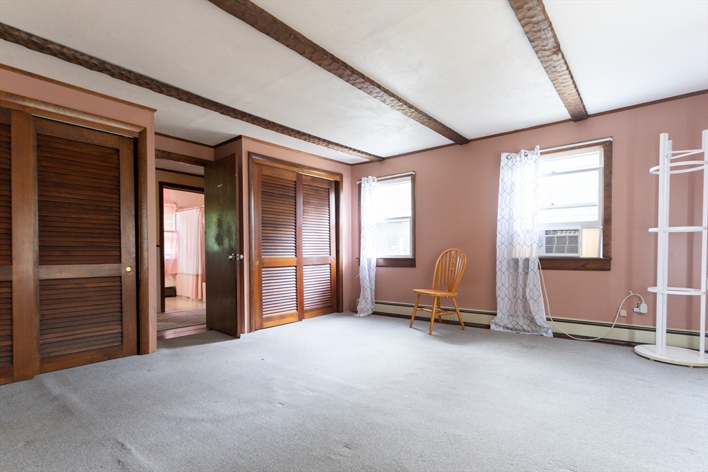 150 Framingham Road, Unit 2 Southborough, MA 01772 - Photo 12 of 20 a view of an empty room with a fireplace and a window