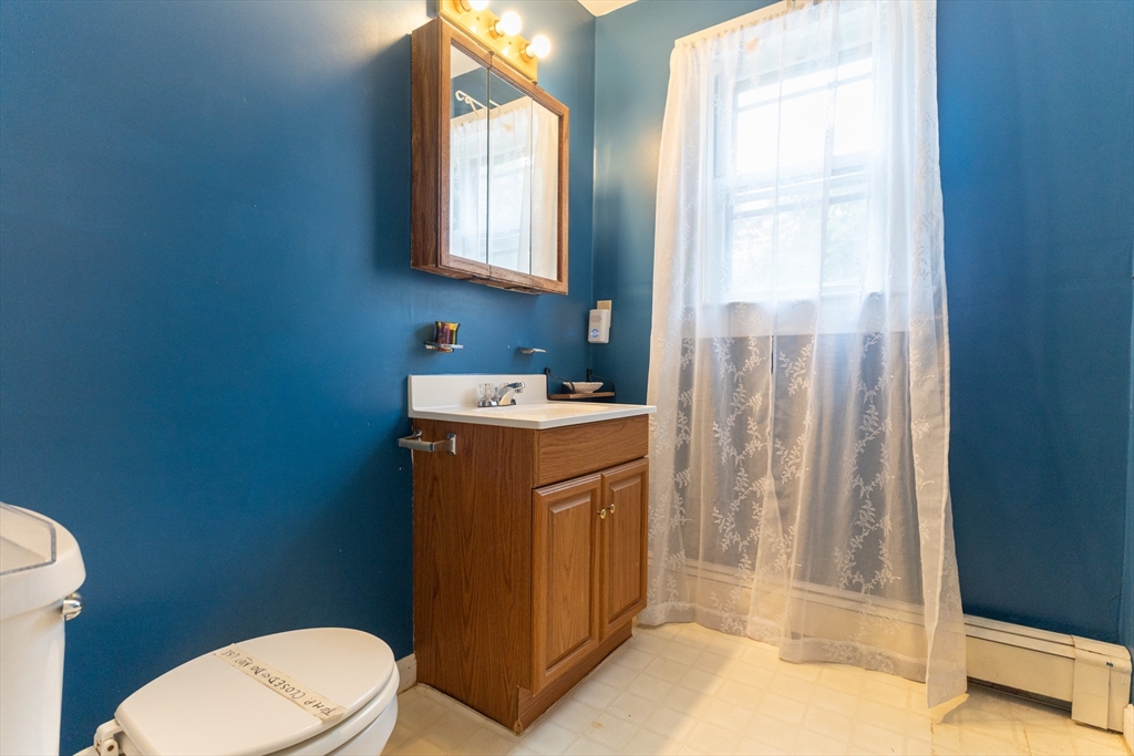 150 Framingham Road, Unit 2 Southborough, MA 01772 - Photo 14 of 20 a bathroom with a toilet a sink and a mirror