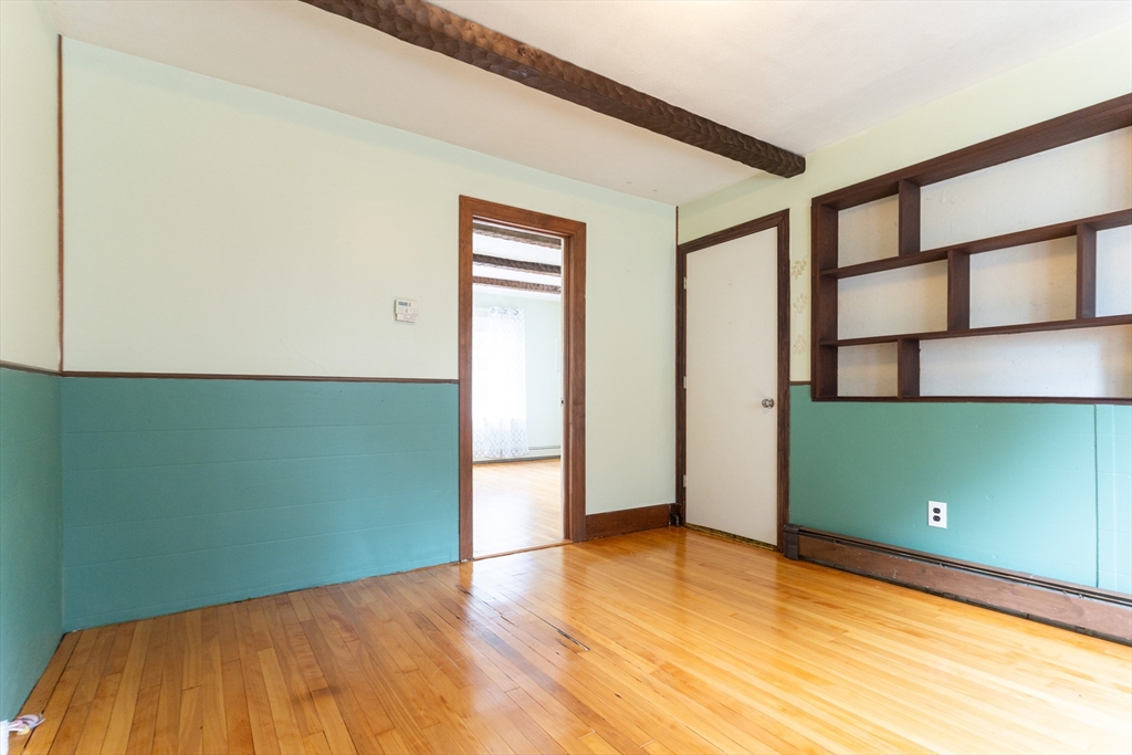 150 Framingham Road, Unit 2 Southborough, MA 01772 - Photo 5 of 20 a view of a room with wooden floor and windows